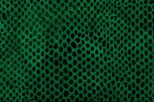 Green leather texture closeup detailed background.