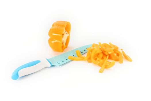 yellow pepper cut with kitchen knife on white background