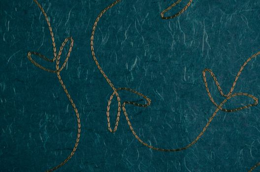 Closeup detail of stitched green recycled paper.