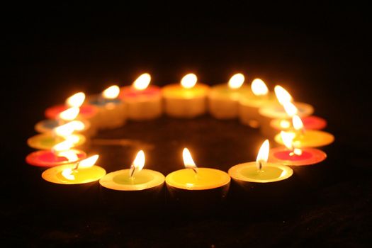 Closeup of burning candles outside in winter time