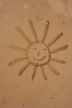 sun symbol written in the beach....