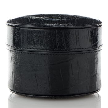 Black leather jewelery box on white reflective background.