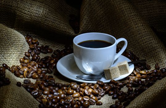 Coffee cup, beans and burlap. still life