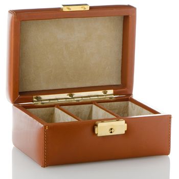 Brown leather jewelery box on white reflective background.