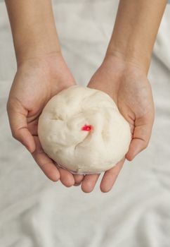 Hand giving a chinese bun