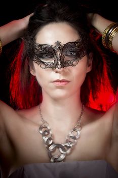 closeup portrait of sexy woman in red party light, venetian mask