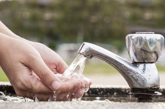 Washing Hands at outdoor     
faucet