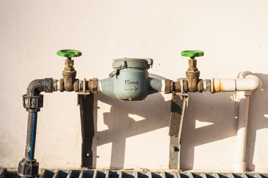 old rusty water pipe, meter and valve