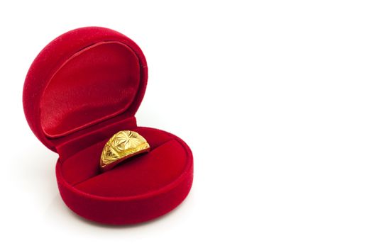 Red velvet box with golden ring