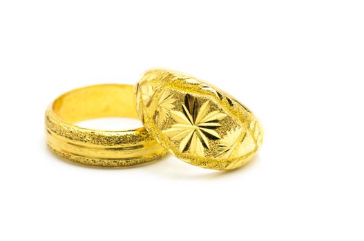 artistic hand made gold rings with grunge texture on white background.