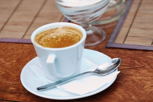 a close up of a cup of coffee on the table 