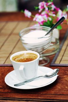 a close up of a cup of coffee on the table 