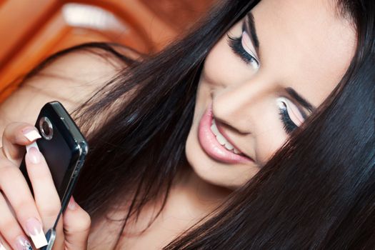 a close up of a brunette texting someone 