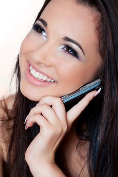 a close up portrait of a brunette beautiful girl talking on the phone