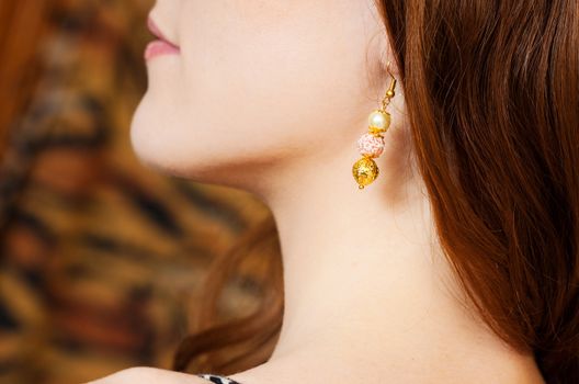 close up picture of redhead beauty wearing earings 