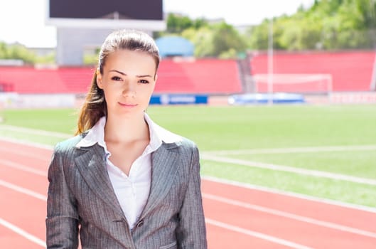 portrait of a beautiful business woman at a sports stadium, the competition in the business