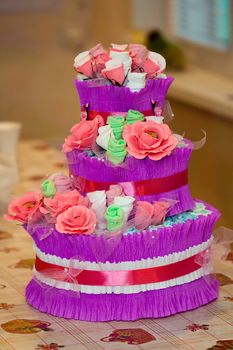 Decorative Cake made of flowers and new babe born's accessories