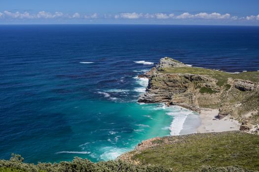 The beautiful coastal lines with blue and turquoise colored water of the Atlantic ocean near Cape Point in South Africa