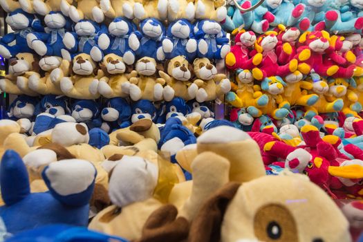 Rows and rows of multi-colored stuffed animals inside of a vending machine