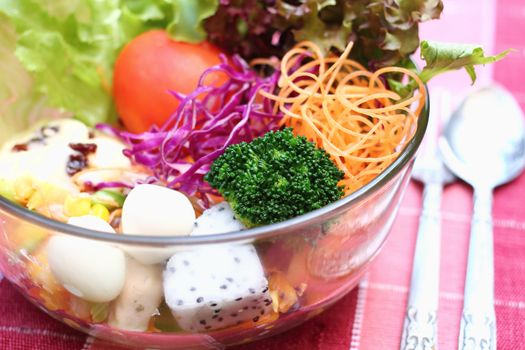 Close up salad in glass bowl with egg, vegetable and fruit