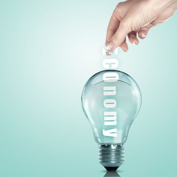 Hand putting a busines term into a light bulb