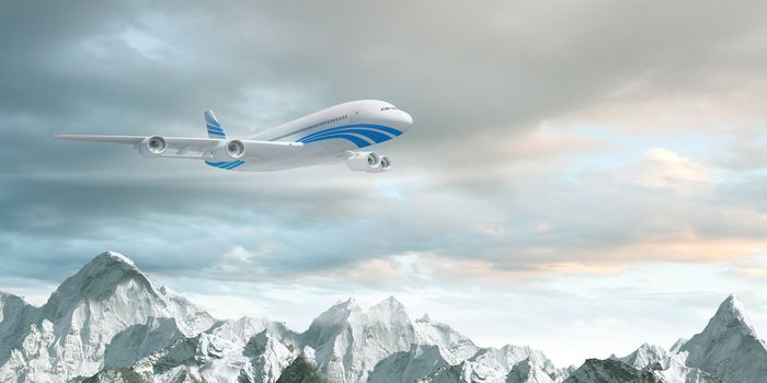 White passenger plane flying in the blue sky above the mountains with snow tops