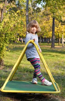 beautiful little girl posing on playground
