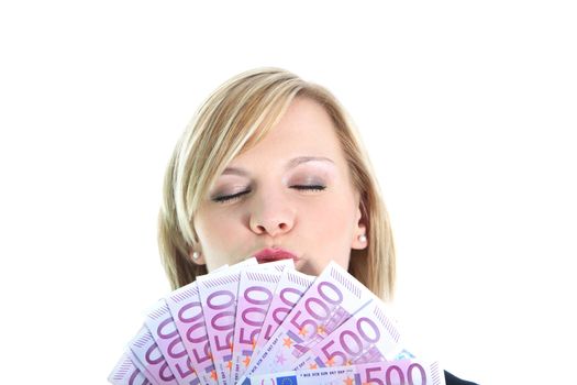 Gleeful woman laughing as she displays a fistful of 500 euro notes fanned out in her hand isolated on white