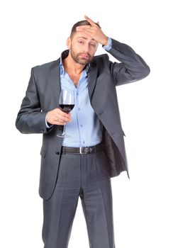 Portrait of thoughtful business man with glass wine, over white background