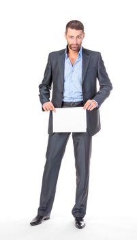 Full length portrait businessman showing an empty board to write, over white background