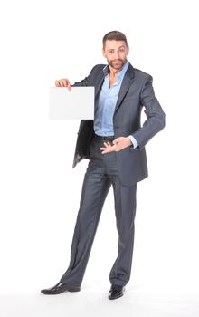 Full length portrait businessman showing an empty board to write, over white background