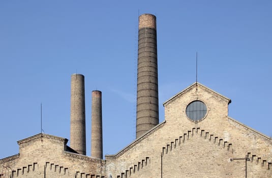 century factory buildings and chimneys.