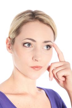 Studio portrait of beautiful young blonde woman touching her head with her finger and thinking