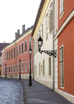 Empty street from the turn of the century, and street lamps.