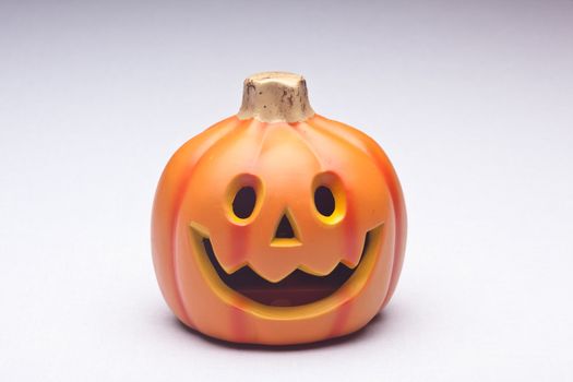 Plastic Halloween Jack o' Lantern decoration imitating curved pumpkin.