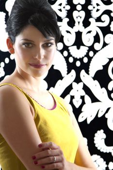 young woman in front of a black and white textured background with 60's inspired style