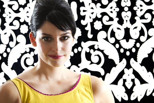 young woman in front of a black and white textured background with 60's inspired style