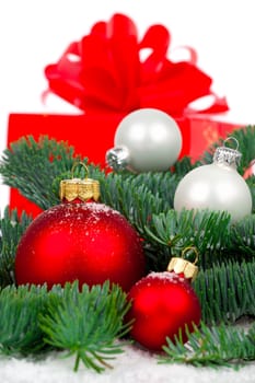 red Christmas ball with pine branch, gift and snow, isolated on white background