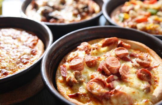 a selection of pizza with various toppings in pan