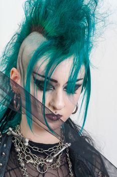 green haired postpunk girl on grey background