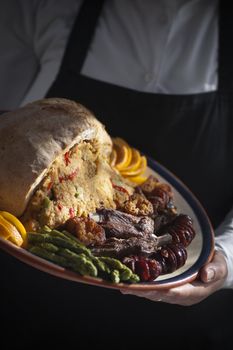 Real food photographed on location in traditional portuguese restaurants, crumbled bread garnished with fried pork spare ribs and smoked sausages - migas com carne de porco - Alentejo, Portugal