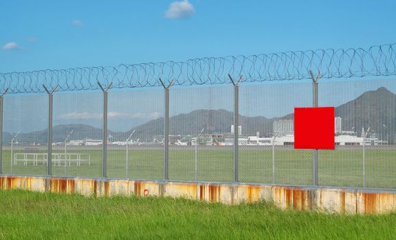 metal fence in the nature and red board for text