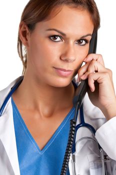 Young female doctor with scrubs and a stethoscope talking on the phone