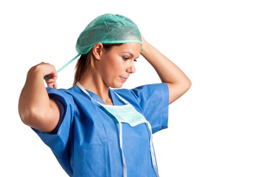 Young female surgeon getting ready for a surgery, isolated in a white background
