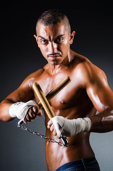 Strong man with nunchaku