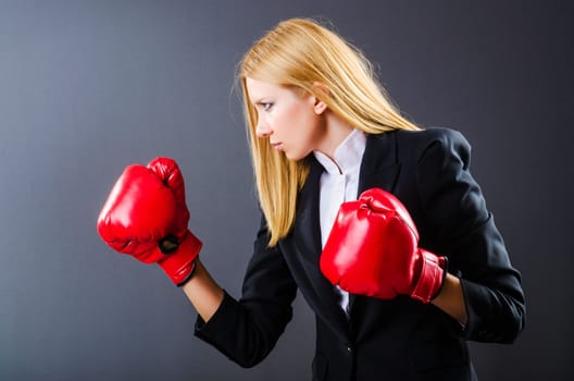 Woman boxer in dark room