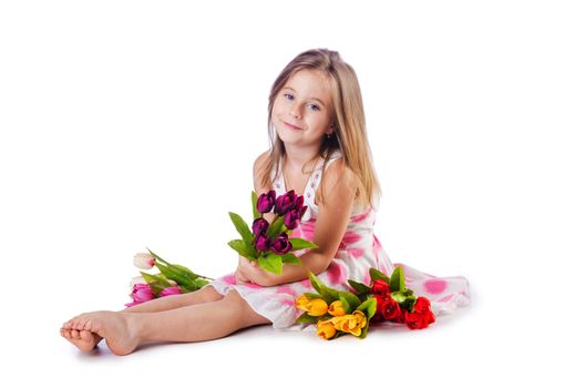 Cute little girl with flowers on white