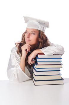 Happy graduate with lots of books on white