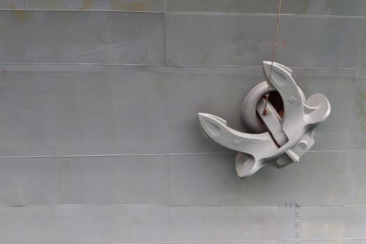 Old anchor on gray background