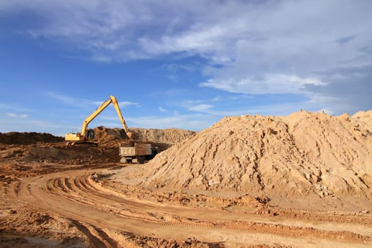 excavator loader machine during earthmoving works outdoors at construction site